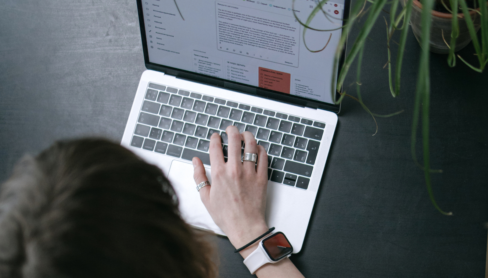 Laptop showing a drafted follow-up email beside a coffee cup